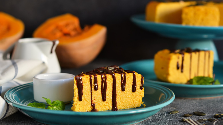 Slices of pumpkin cheesecake with chocolate drizzle