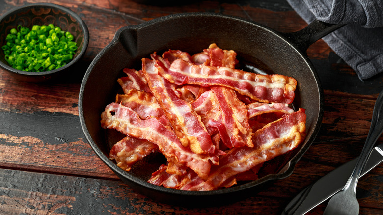 bacon strips in an iron pan