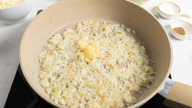 chopped onion and garlic in pan