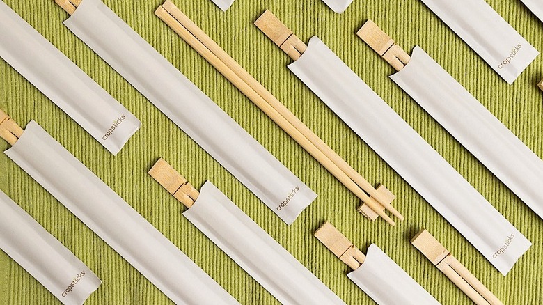Cropsticks chopsticks laid out on green fabric