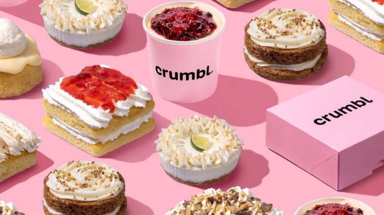 Boxes of Crumbl cookies next to various Crumbl desserts