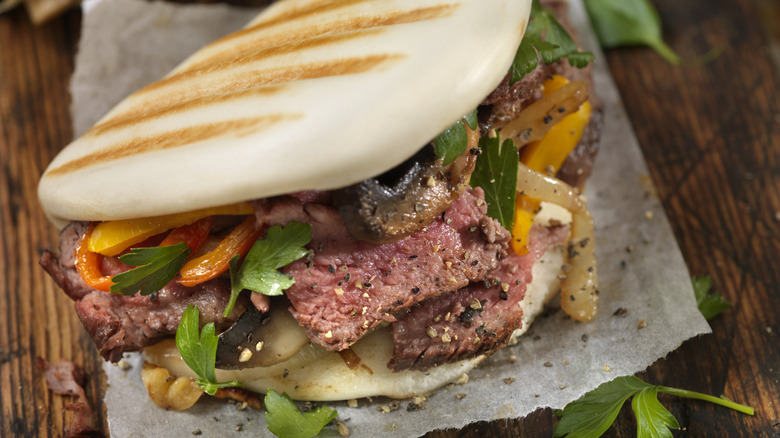 seared bao bun with pepper steak and sauteed vegetables