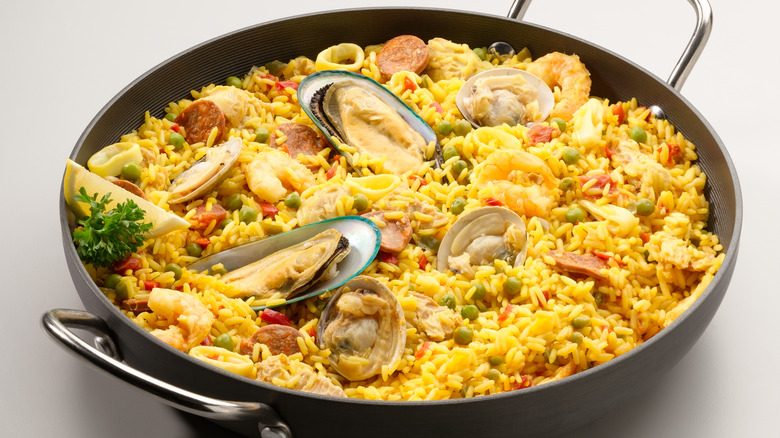 side view of traditional paella with seafood