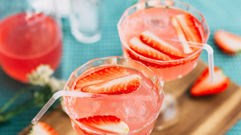 Strawberry-flavored cocktails with sliced strawberry garnish