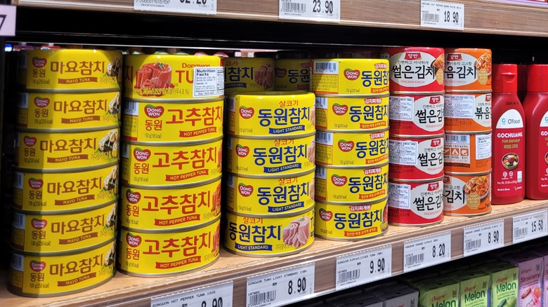 Cans of Dongwon tuna on supermarket shelf