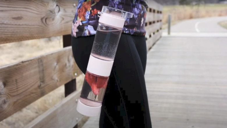 water bottles with fruit pieces hanging on belt