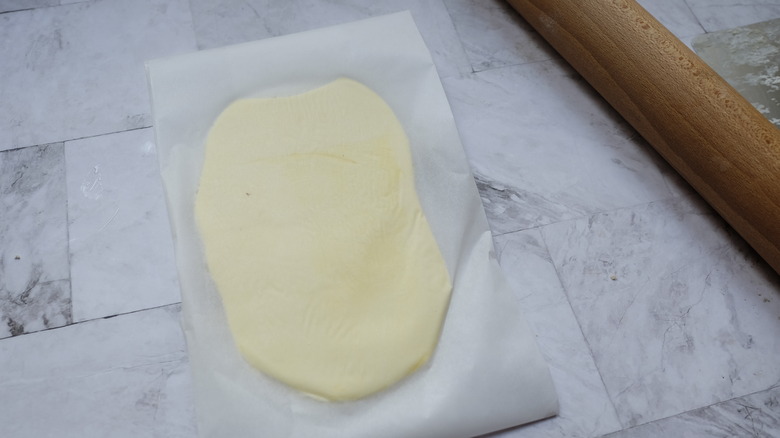 croissant dough between parchment paper