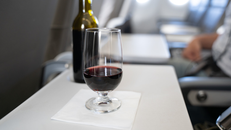 bottle and glass of wine in airplane