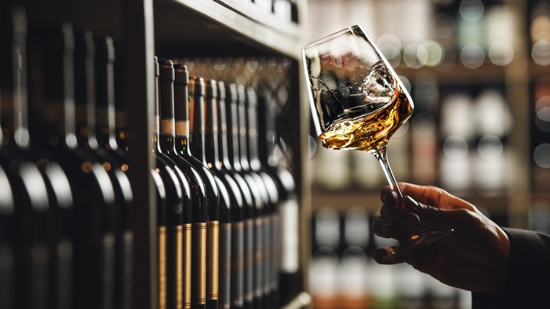 Sommelier swirling wine in a glass to open its aromas