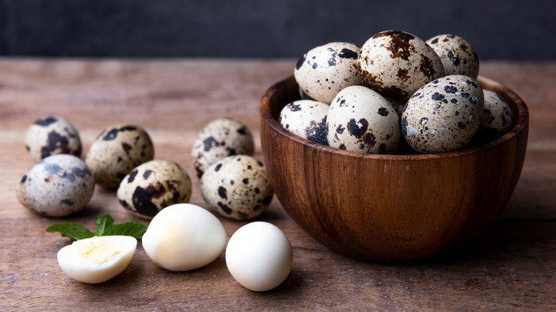 Quail eggs in wooden bowl