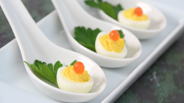 Deviled quail eggs on spoons