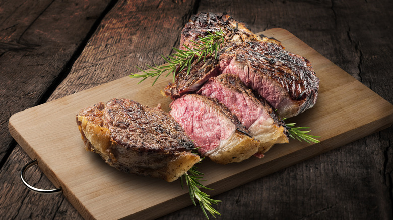 Cooked T-bone steak on cutting board