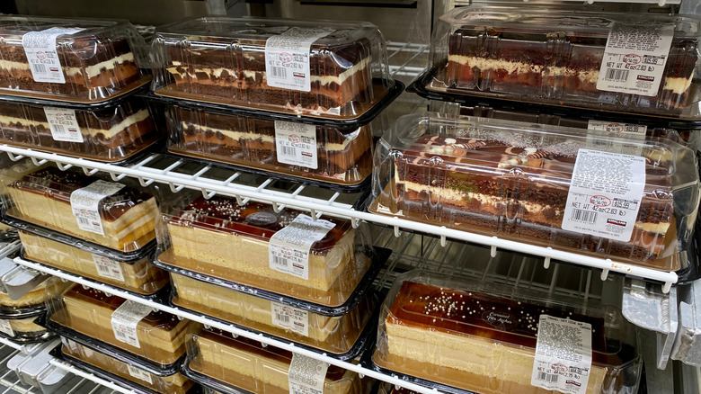 Containers of Costco's Tuxedo Chocolate Mousse cake sit in a fridge