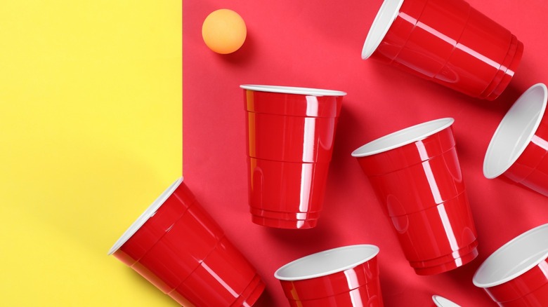 Red solo cups on a yellow and red background 