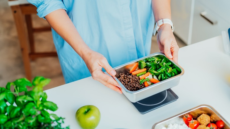 person using digital kitchen scale