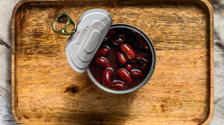 can of kidney beans open on cutting board