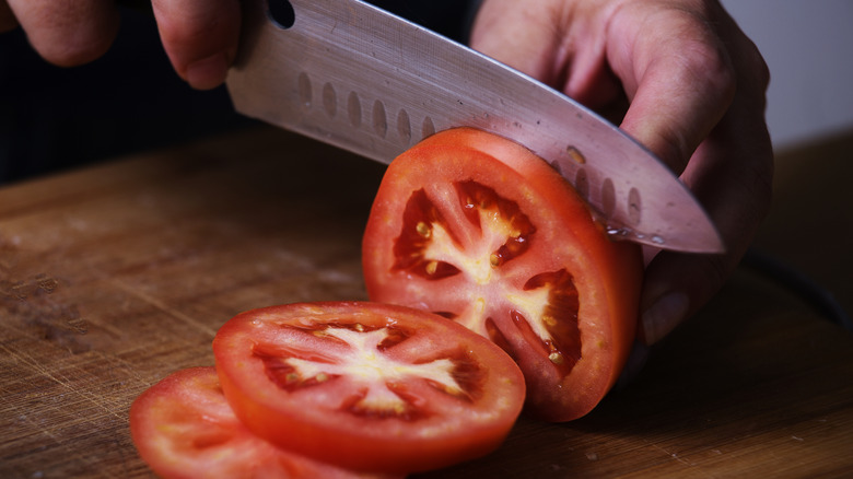 A knife slicing an onion