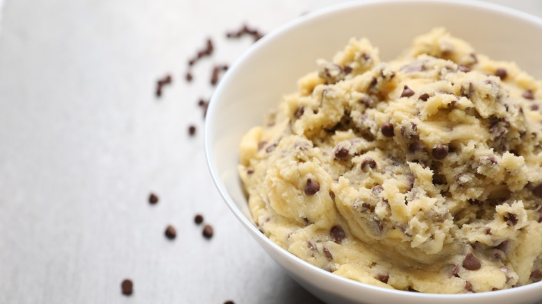 Chocolate chip cookie dough in a bowl on a white background