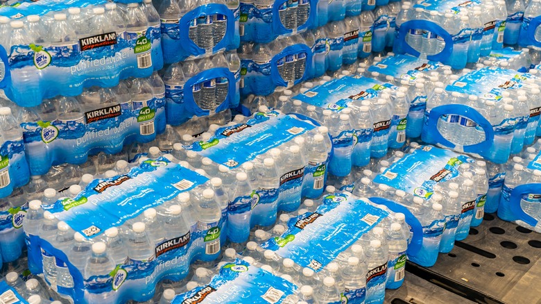 Crates of Kirkland Signature water bottles stacked on top of each other at a Costco warehouse