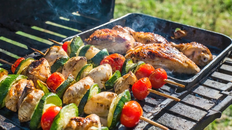 Chicken and vegetables kebabs on hot grill