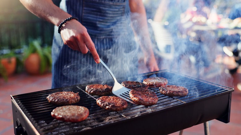 Burgers being cooked on a hot grill