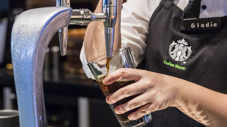 Barista pouring Starbucks nitrogen iced coffee