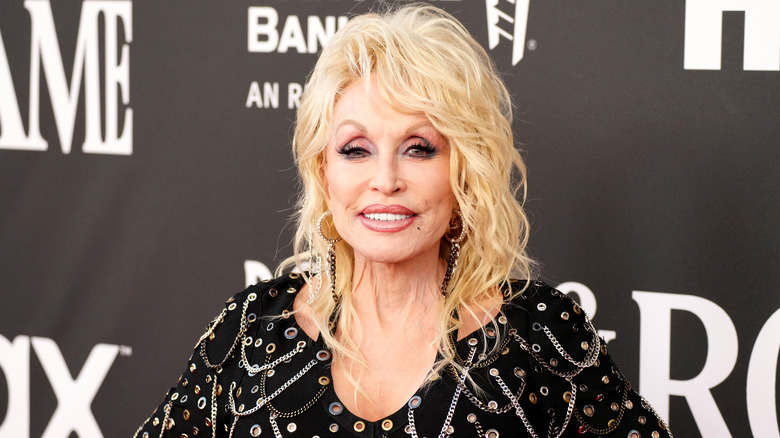 Dolly Parton on black dress with chains