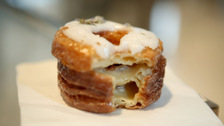 A white frosted Cronut from Dominique Ansel on white napkin