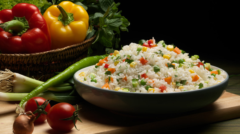 Sweet Corn, red bell pepper, green peas delicious healthy Risotto. Rice with vegetables.