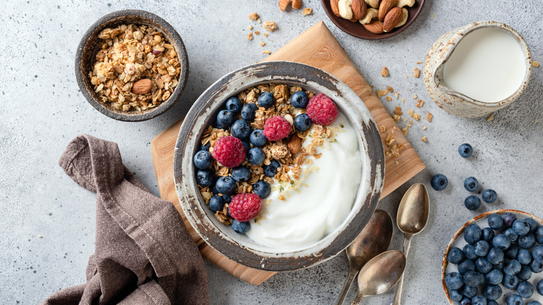 A bowl of homemade yogurt topped with granola and mixed berries