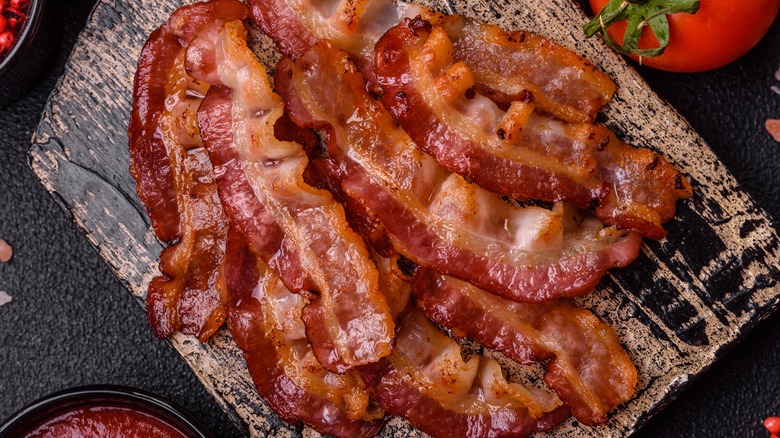 cooked bacon on wooden plate