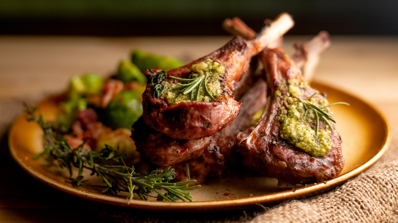 Lamb chops on copper plate with rosemary