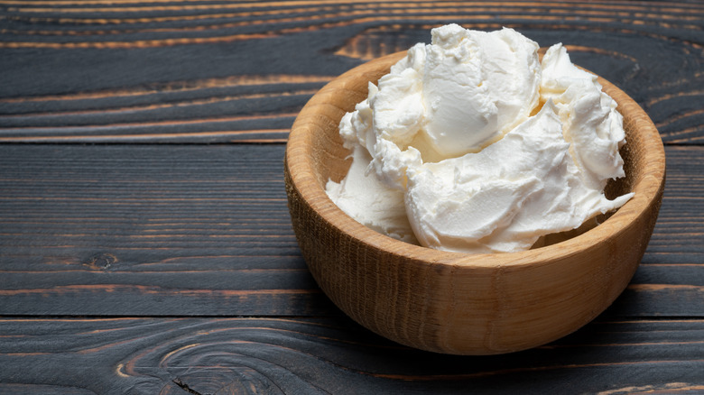 Wooden bowl with mascarpone cheese