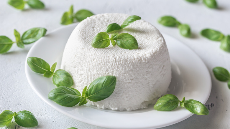 dollop of ricotta with sprigs of fresh basil