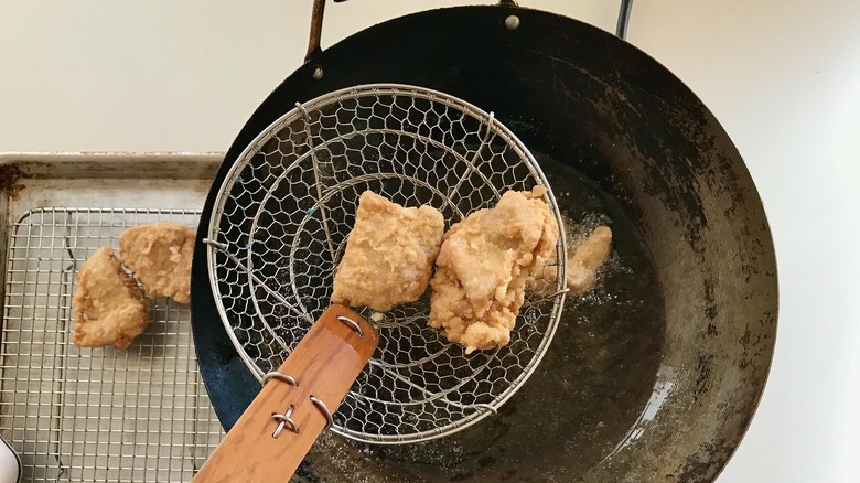 fried chicken above oil pot