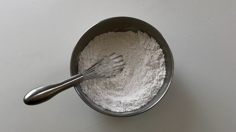flour in metal bowl with whisk