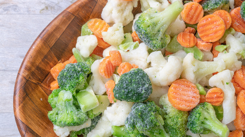 frozen medley of broccoli, cauliflower, and carrots in wooden dish