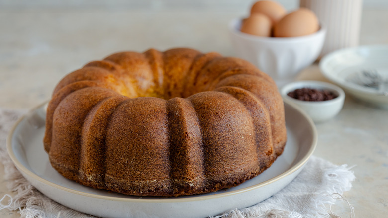 Bundt cake with eggs and spices in the background