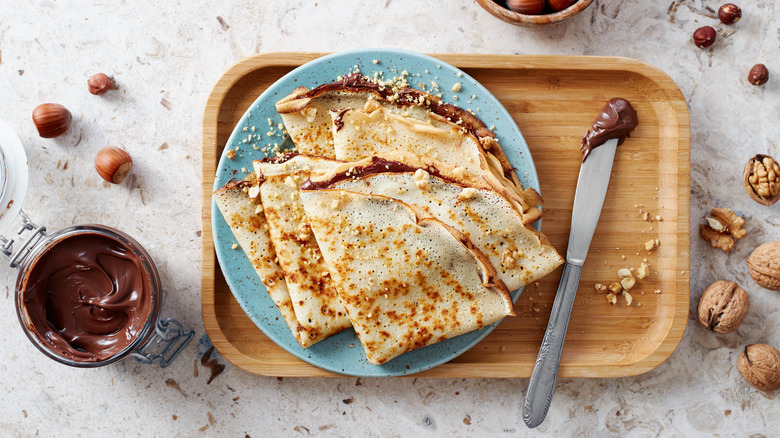 crepes on plate with hazelnuts and spread