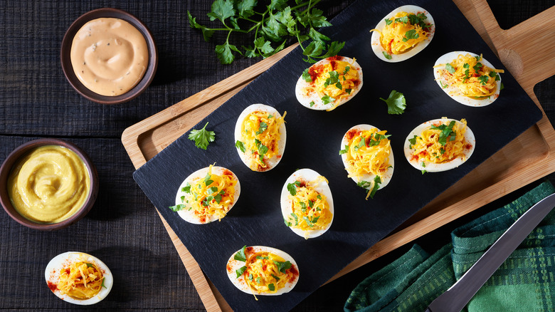 deviled eggs on wooden board