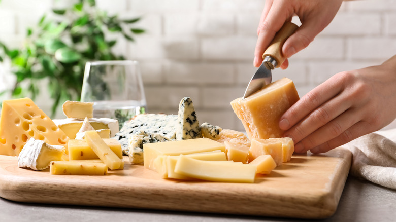 person cutting cheese