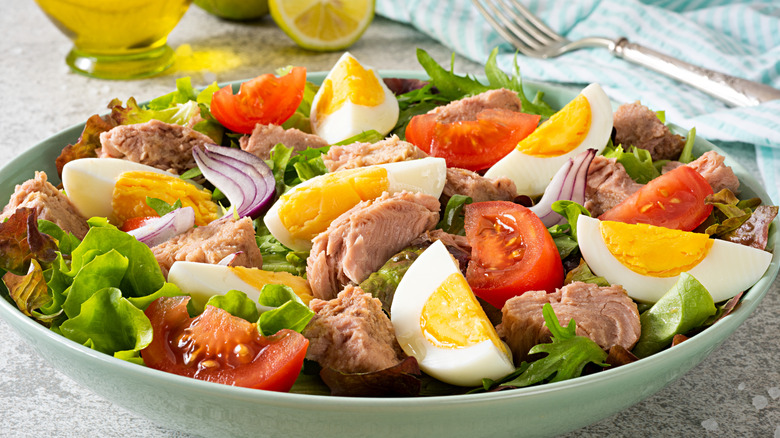 Salad with sliced eggs, tomatoes, tuna fish