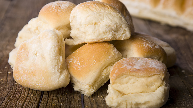 A pile of dinner rolls on a counter