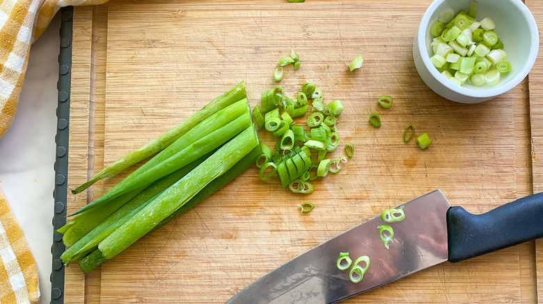 scallion being cut on board