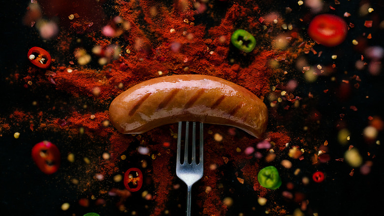 Sausage surrounded by peppers and spices