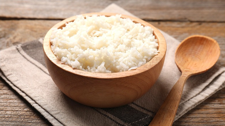 Cooked white rice in wooden bowl