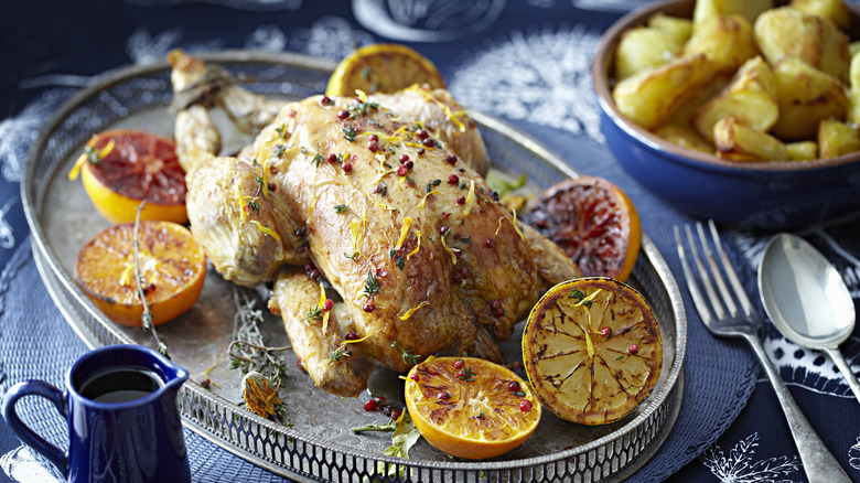 A roast chicken seasoned with Mediterranean spices and herbs