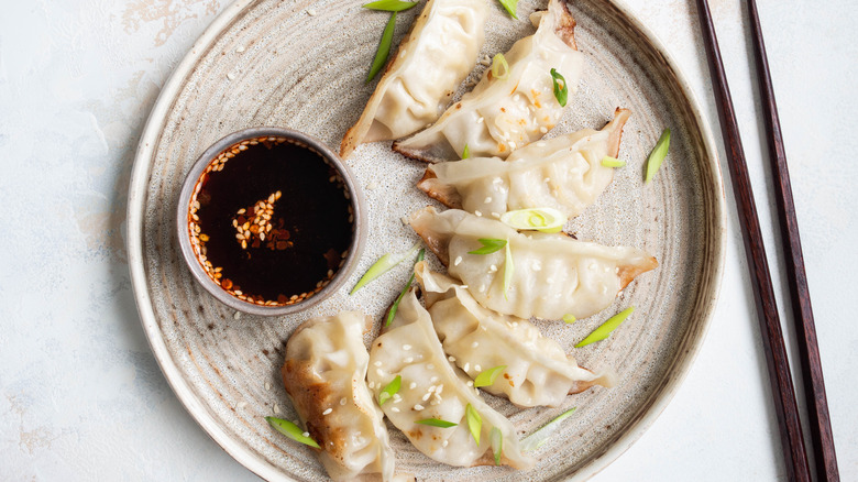 Plate of gyoza with side of soy sauce