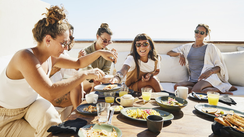 Friends enjoying brunch outside in the sun