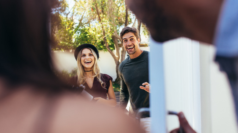 Couple arriving at home too late for the party